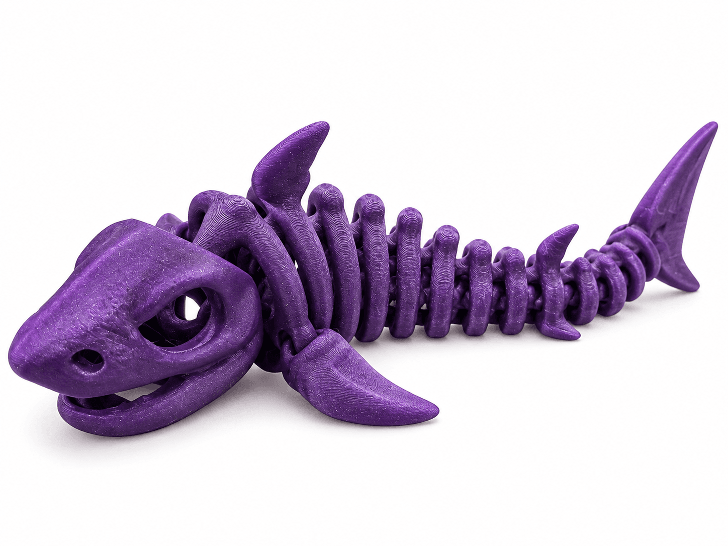 Purple articulated 3D printed shark skeleton with segmented spine and fins